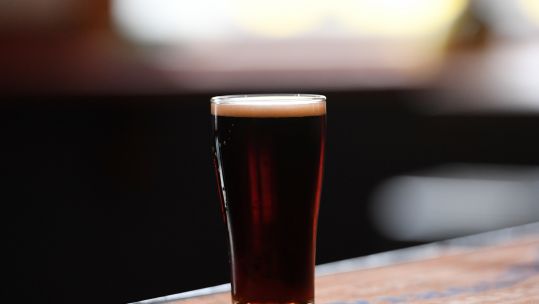 Pint of White Rabbit Dark Ale beer anonymous at a bar
