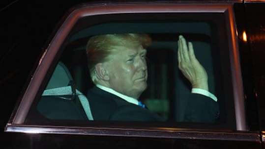 Mr Trump waves as he heads to his hotel (Picture: PA). 