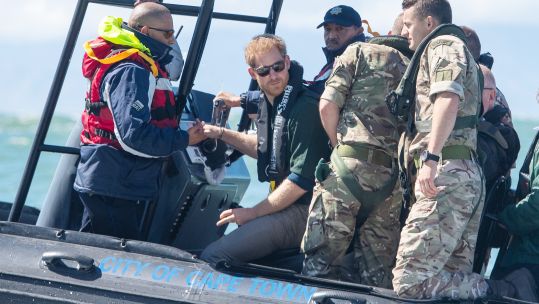 Prince Harry travelled along the coastline of Kalk Bay Harbour, south of Cape Town (Picture: PA). 