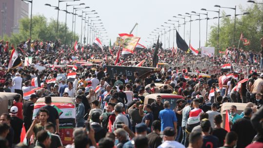 Protesters try to cross al-Jumhouriya bridge to reach the Green Zone in Baghdad, Iraq, on 251019 CREDIT PA.jpg 