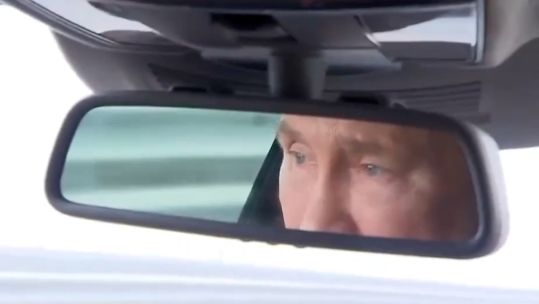 Putin in rear miror driving a car CREDIT KREMLIN