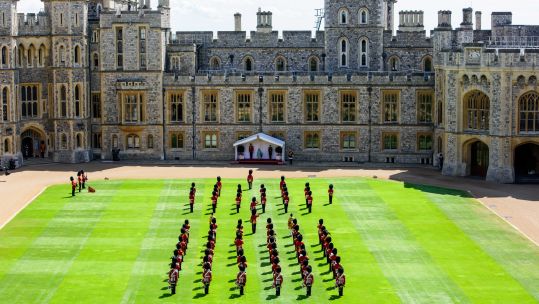 Queen Elizabeth II watches a ceremony in the Quadrangle of Windsor Castle in Berkshire to mark her official birthday 130620 CREDIT PA
