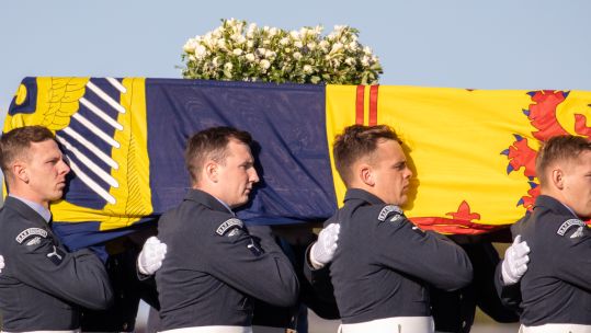 Members of the Queen's Colour Squadron (RAF Regiment) carried the Queen's coffin onto a C-17 at Edinburgh Airport yesterday