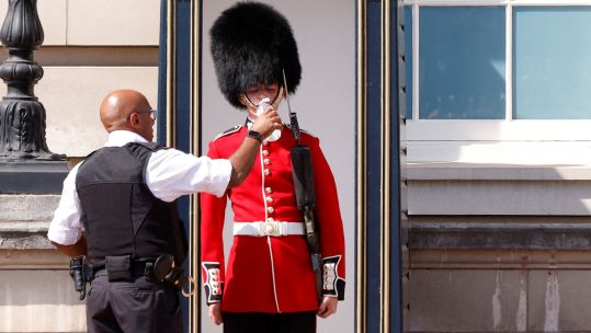 Queen's Guard being given water 