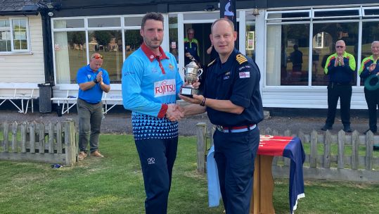 RAF Captain Tom Shorthouse receives the Harrier Trophy from Captain Ainsley for beating the Royal Navy in IS 50-over cricket