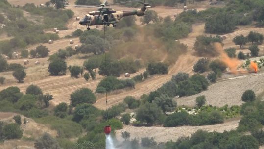RAF Puma helicopter carries out firefighting drills in Cyprus.