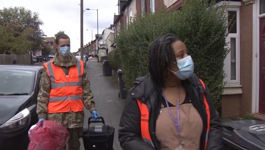 Sergeant Jonathan Hill and Birmingham City Council's Sophie Murray help to deliver coronavirus test kits to people in Birmingham.