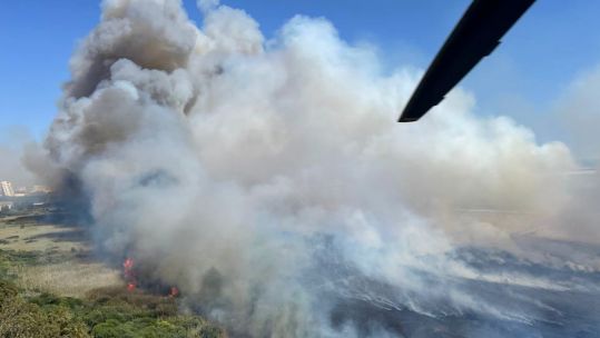 Smoke rises from the fire