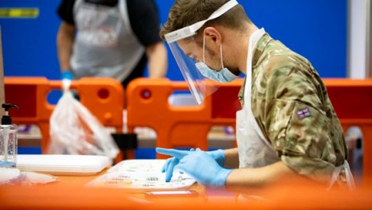 Cover image: RAF service member during a coronavirus testing scheme in Merthyr Tydfil, Wales (Picture: MOD).