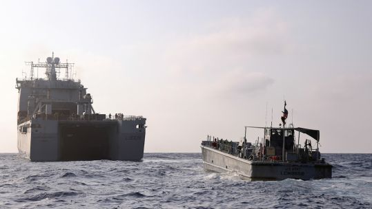 RFA cardigan bay with a us water craft sailing to the gaza pier