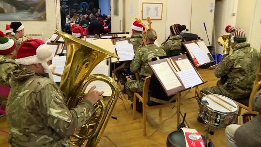 Regimental 3PWRR band plays at a homeless centre.
