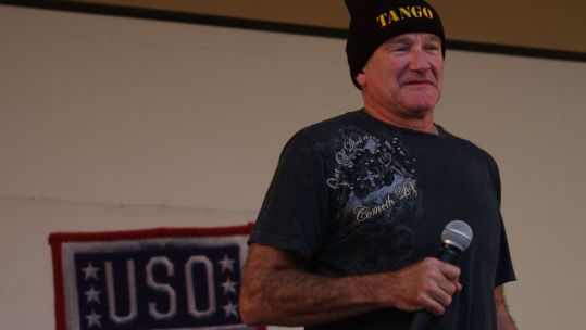 Robin Williams entertains troops at Camp Arifjan, Kuwait, during a USO visit in December 2007 DVIDS Image ID 69438 CREDIT Department of Defense