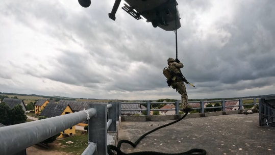 	Royal Marine Commandos fast roping out of a Merlin helicopter whilst taking on urban training on Salisbury Plain