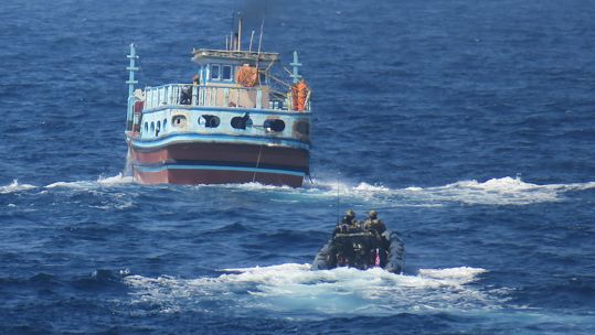 Royal Marines approaching the suspected boat in the Arabian Sea (Picture: Royal Navy).