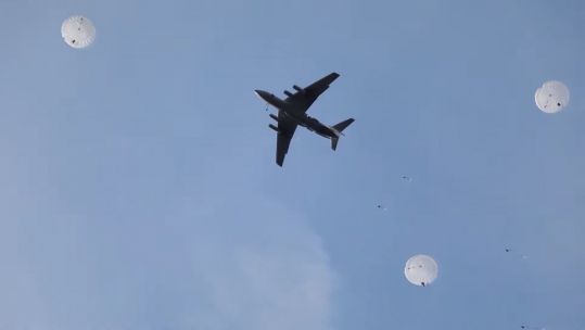 Russian forces parachute as part of exercises near the border with Ukraine (Picture: Russian Ministry of Defence).