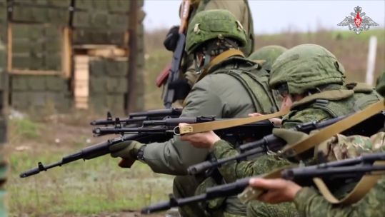 Russian soldiers firing weapons (Picture: Ukrainian MOD).