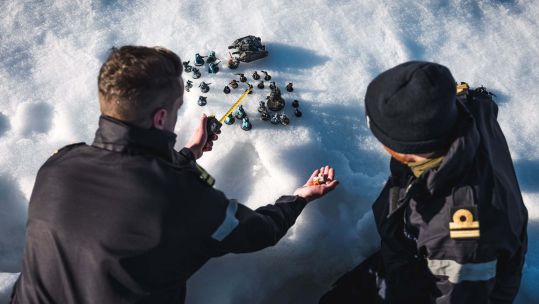 Sailors from HMS Protector playing warhammer, Dice on the Ice with Lts Jonny Talbot left and Max Friswell