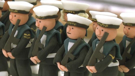 Sailors on HMS Prince of Wales' ceremonial cake.