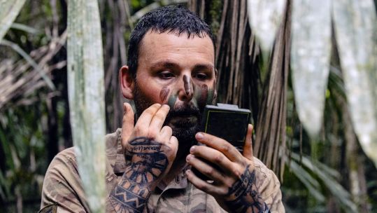 A Scots Guard applies camouflage cream before live firing range in Belize on Exercise Mayan Storm 20112021 CREDIT MOD Crown.jpg