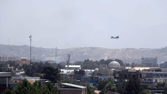 A Sea Knight military transport helicopter flies over Kabul as Taliban enters Kabul and West evacuates (Picture: UPI, Alamy).