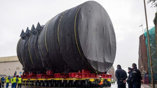 Section of HMS Dreadnought being moved through streets of Barrow-in-Furness 
