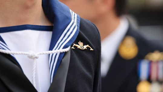 Semi-anonymous sailor with submarine service pin at HMS Audacious commissioning