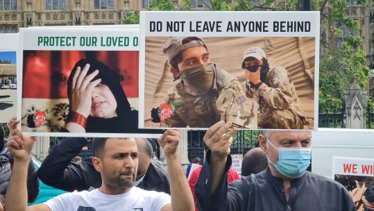 Signs held up by demonstrating military veterans and former Afghan interpreters over those still in Afghanistan 180821 CREDIT BFBS