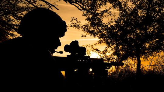 Silhouette of Anonymous soldier of 34 Squadron, RAF Regiment, taking cover in a defensive position after coming under contact from enemy forces during a late afternoon patrol (Picture: MOD).