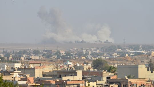 Smoke rises from Syrian city of Ras al Ain following an attack from Turkey (Picture: PA).