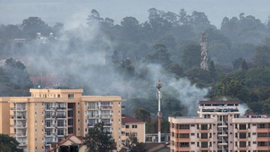 Smoke rises from the blast area after an attack at an upmarket hotel and office complex in Nairobi (Picture: PA).