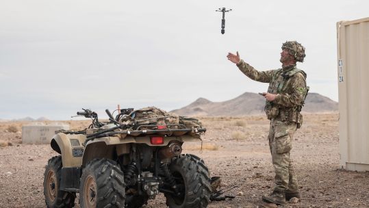 A soldier uses a drone to scout enemy locations on exercise
