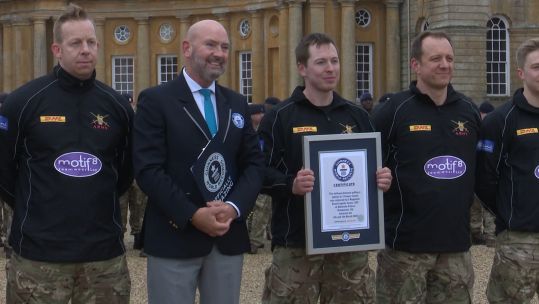 Soldiers from RLC proudly hold Guinness World Record certificate after pulling a van 