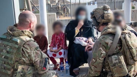UK personnel talking with Afghan families during Operation Pitting in August (Picture: MOD).