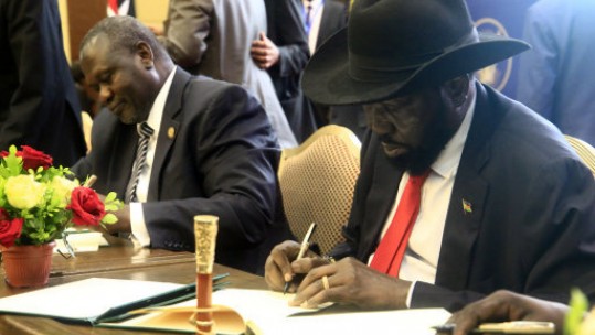 South Sudanese President Salva Kiir (right) and major opposition leader Riek Machar sign the final deal on power-sharing (Picture: PA).