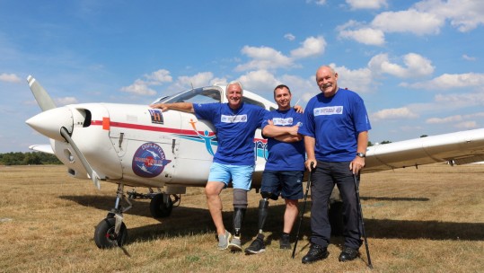 Spitfire Sir Douglas grandson with disabled pilots CREDIT SWNS.jpg