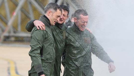 Squadron Leader Chris Whitehair, Croup Captain Ian Townsen and Air Chief Marshal Sir Stephen Hillier getting soaked at RAF Marham
