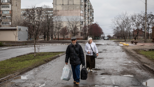 People returning to their homes amid housing estate after the explosion of a rocket on the eastern edge of Mariupol
