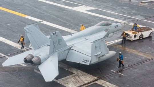 The incident involved an F/A-18E Super Hornet and tow tractor similar to these