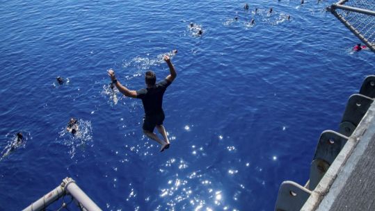 Sailors assigned to the Harry S. Truman Carrier Strike Group swim in the Mediterranean Sea during a swim call, July 26, 2022. (Picture: Petty Officer 3rd Class Crayton Andrew / USS Harry S Truman).