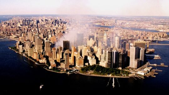 The World Trade Center complex continues to burn, while the Coast Guard Cutter Tahoma controls vessel traffic in New York harbor September 15