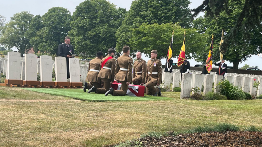 The bearer party fold the flag on Pte Birch's Coffin CREDIT MOD