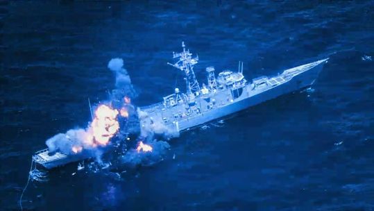 The decommissioned ex-USS Rodney M. Davis being fired upon in a joint exercise between the Hawaiian islands and southern California