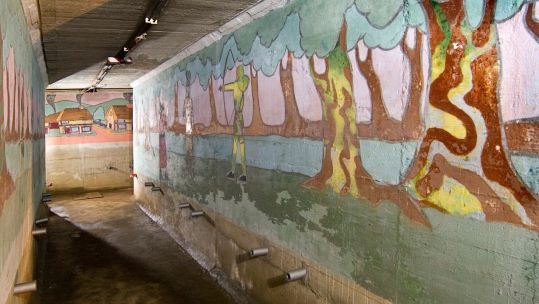 Cover image: TheSt John’s School boys' air raid shelter includes a number of murals, depicting scenes from stories such as Treaure Island and Robin Hood (Picture: Historic England Archive).