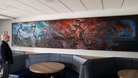 Falklands veteran Mark Eve takes a look at the striking artwork (Picture: MOD).