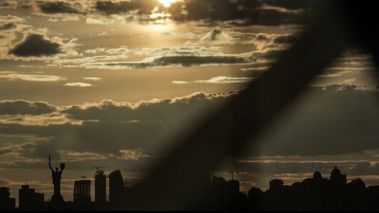 The sun shines through the clouds over the Motherland Monument, Kyiv, capital of Ukraine on 27 February (Picture: Ukrinform/ Alamy Live News).