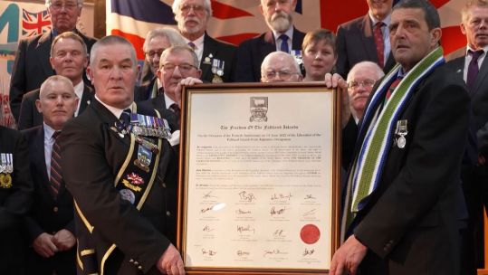 The Freedom Of The Falkland Islands framed letter with veterans CREDIT BFBS