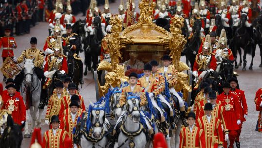 Their Majesties The King and Queen Consort departed Westminster Abbey in the Gold State Coach, flanked by military personnel