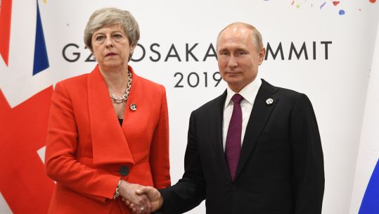 Theresa May and Vladimir Putin shake hands at G20 summit in Japan