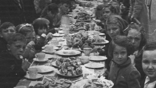 Dave Hemstead sent us this picture of his mother, Pauline (fifth on right), celebrating VE Day on Langton Street, London. Credit: Dave Hemstead. 