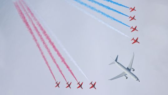 Trails seen behind the Red Arrows flanking a Poseidon aircraft in a display over Scotland (Picture: MOD).
